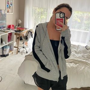 grey zip up H&M hoodie with black straps on sleeves